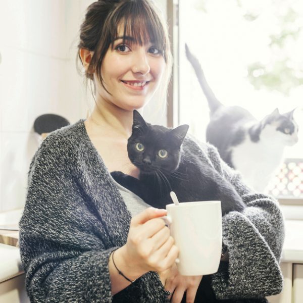 happy-woman-with-cup-coffee-holding-her-cat_23-2147860403